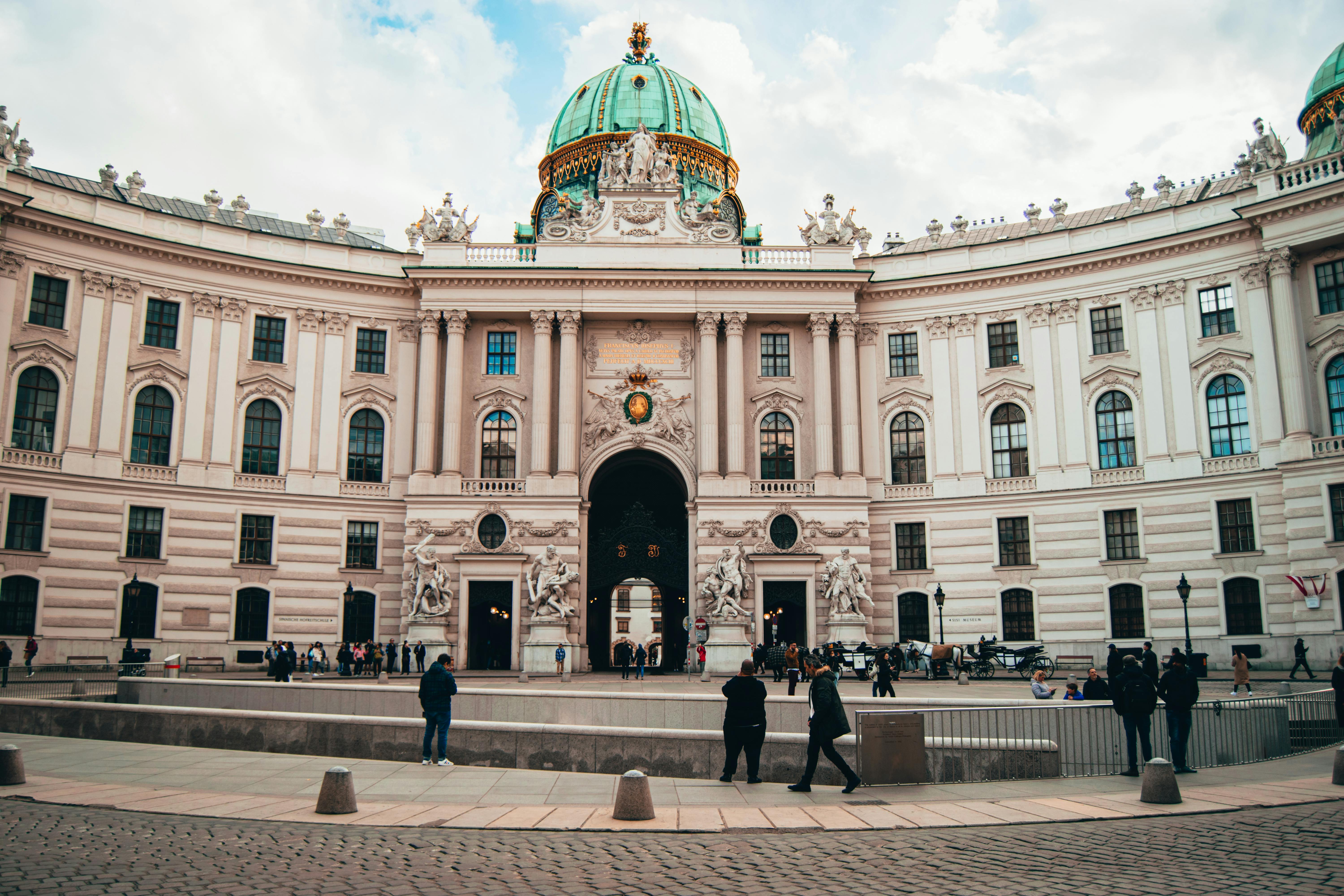 Vienna City Attractions Historic imperial palace with ornate architecture and lush courtyard