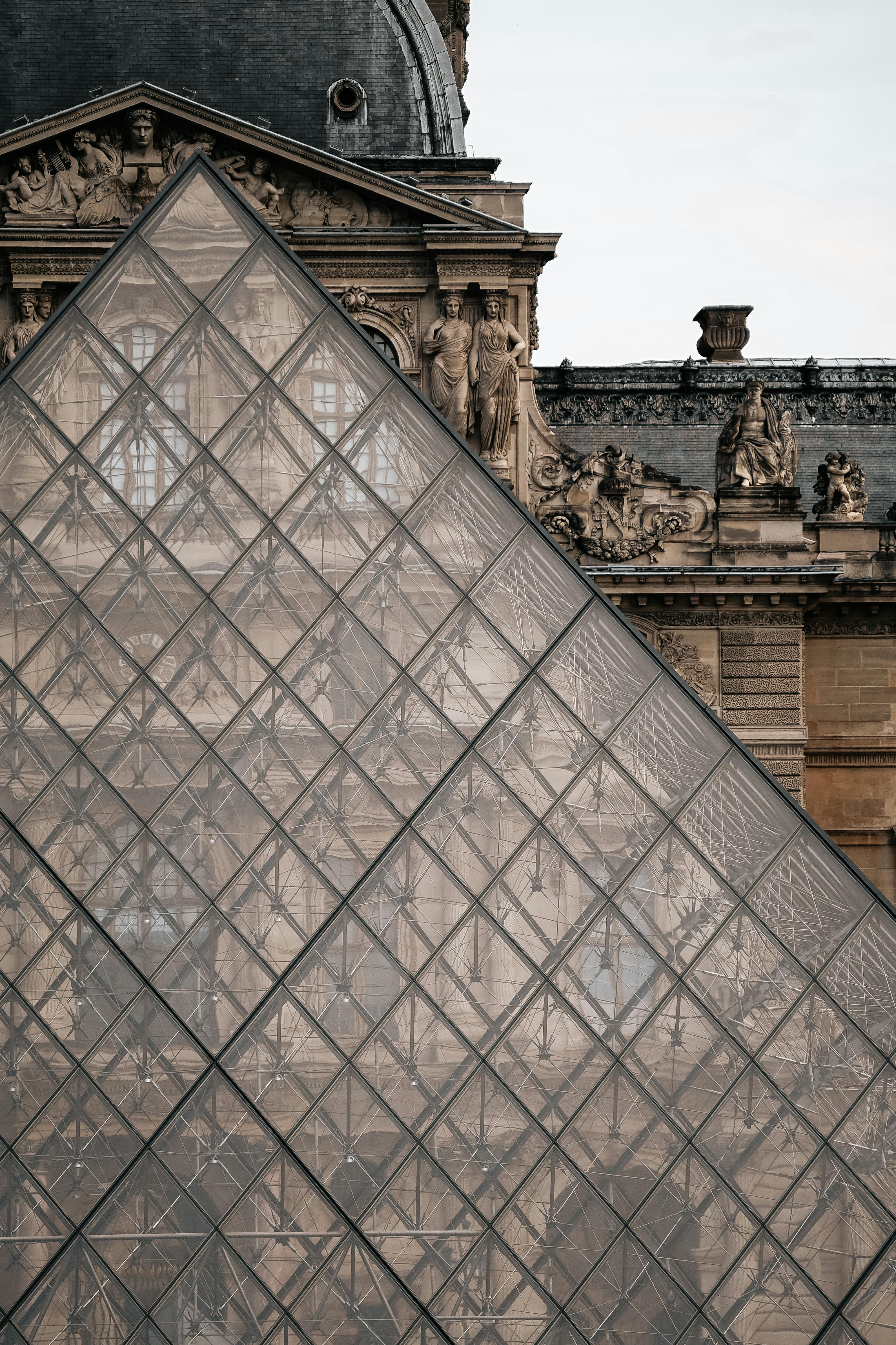 Paris Travel Attractions Louvre glass pyramid entrance with museum facade